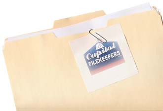 Manila folder and paper clipped note isolated on white with capitol filekeepers logo